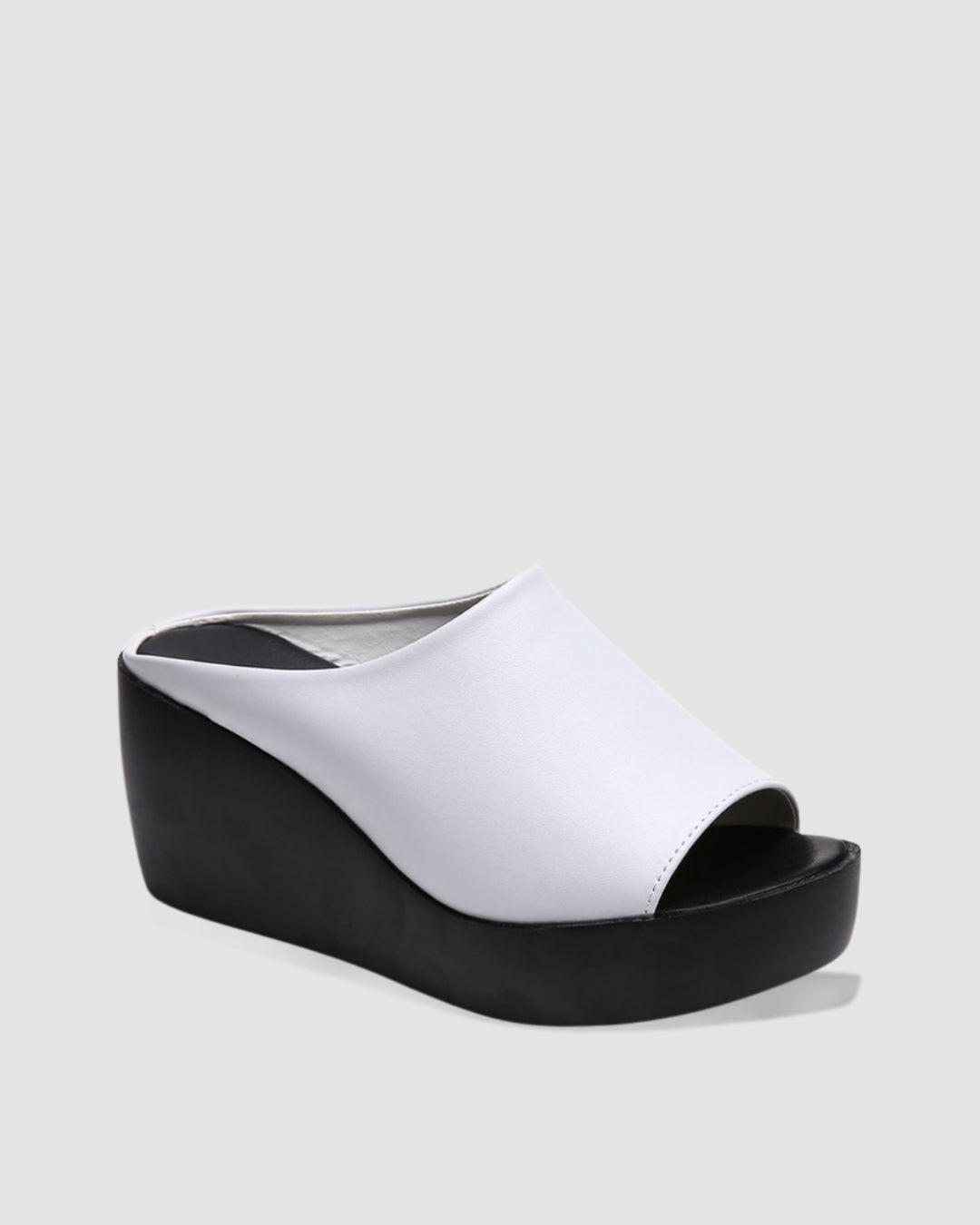 White platform wedge sandals with an open toe and black wedge heel.